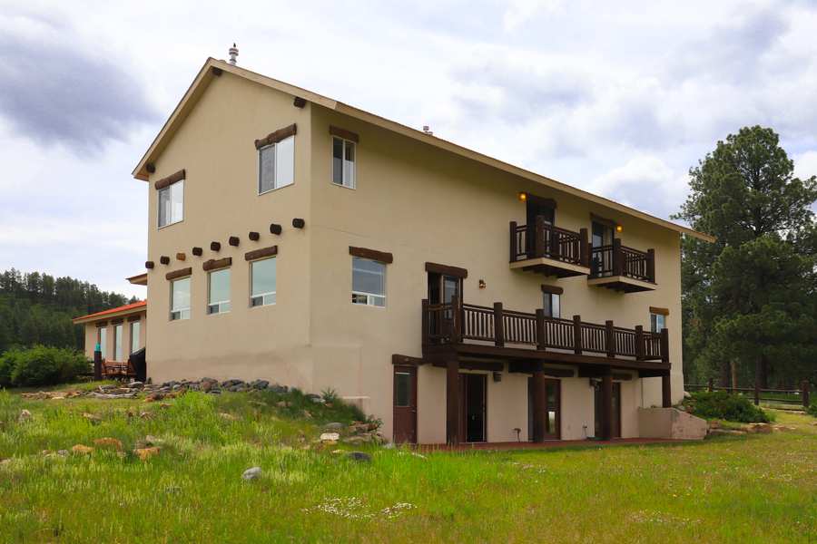 West side of the lodge showing three levels, log balconies and the walkout lower level