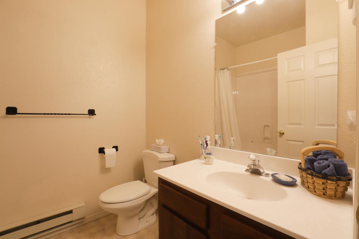 Private bathroom with a vanity and tub