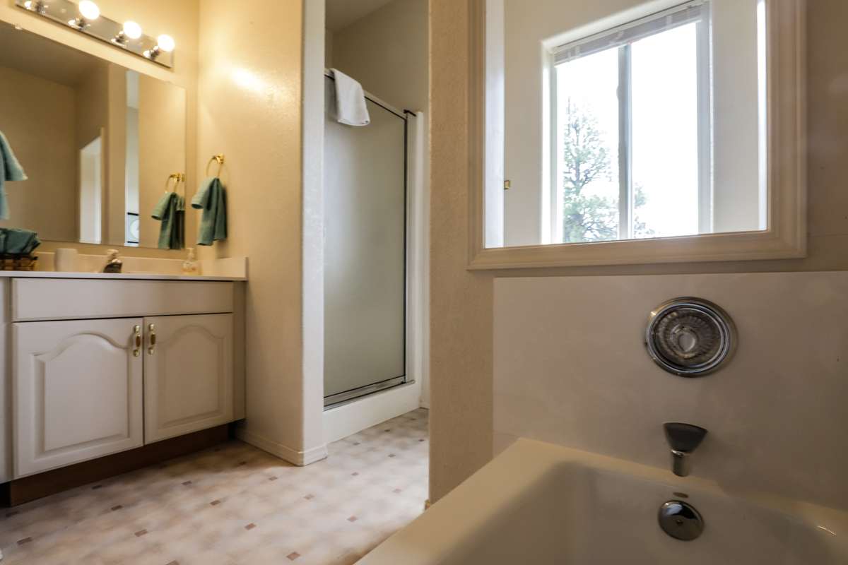 Private bathroom with a soaking tub and separate shower