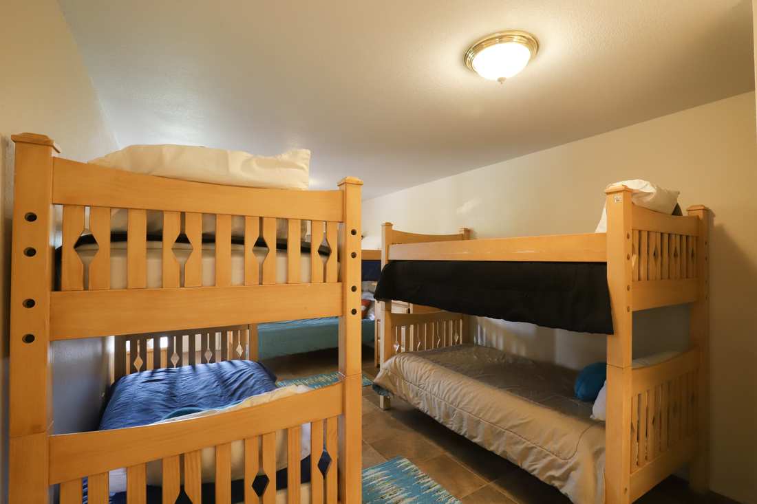 Bunk room with two sets of wooden bunk beds