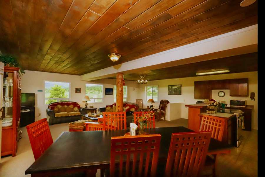 Dining table with seating for the group, living area and kitchen beyond